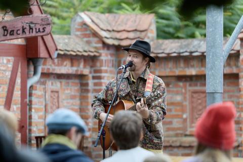 Ein Musiker mit Gitarre spielt im Museumshof